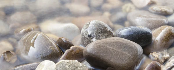 Rounded stones in water — Stock Photo, Image