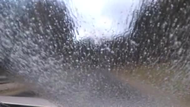 Car driving and cleaning windshield with wipers — Stock Video