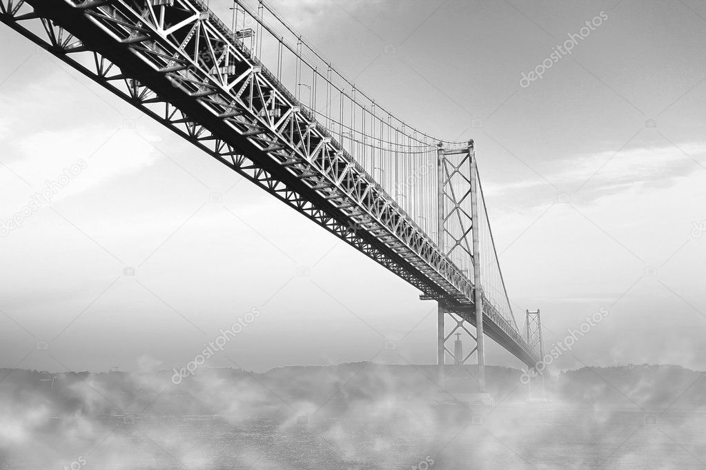 The bridge of April 25 with a fog on a river, Lisbon, Portugal. Monochromatic picture