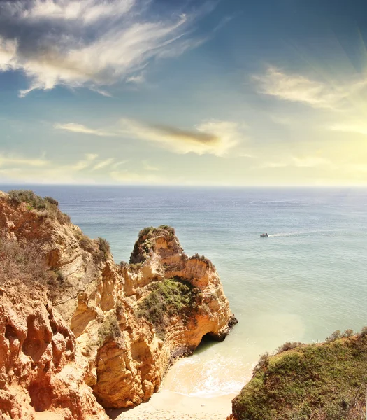 Rocky beach at sunset, Lagos, Portugal. Counter light. Travel and business background — Stock Photo, Image