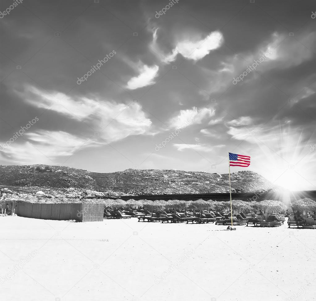 Patriotic USA background with American flag on the sandy beach a