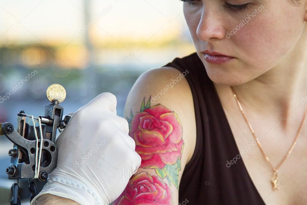 Tattooer showing process of making a tattoo on young beautiful hipster woman with red curly hair hand. Tattoo design in the form of rose Stock Photo by ©sergeialyoshin 89637810