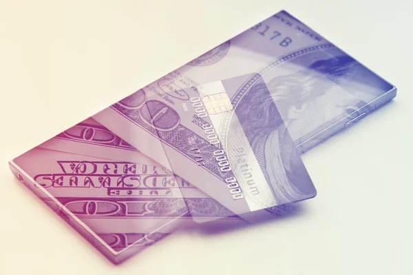 Dubbele blootstelling: creditcard op hundres dollar bills close-up — Stockfoto