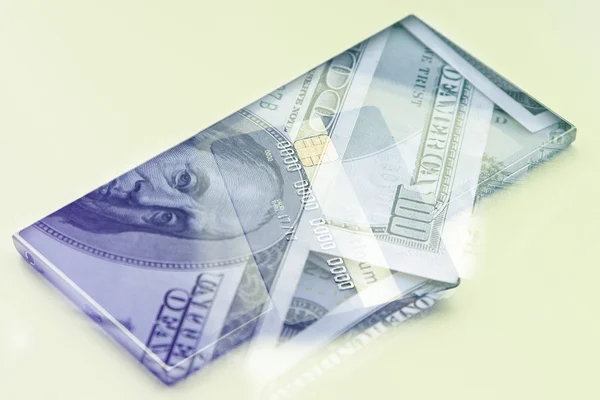 Dubbele blootstelling: creditcard op hundres dollar bills close-up — Stockfoto