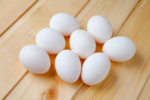 stock image White eggs on a wooden table