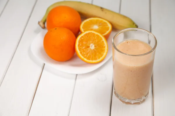 Healthy drink orange and banana smoothies on wooden table — Stock Photo, Image