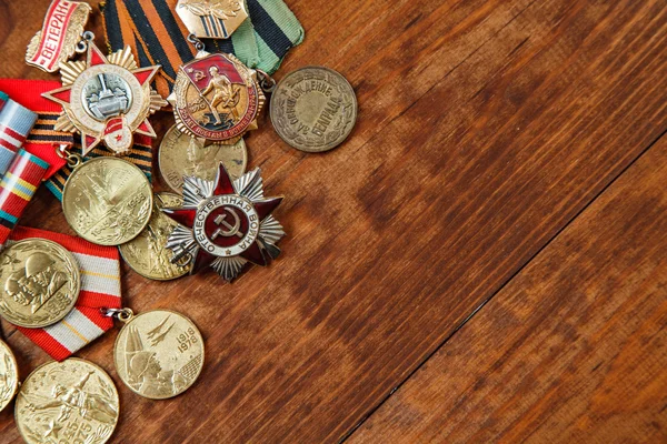 Orden des patriotischen Krieges in St. und Medaillen für den Sieg über Deutschland auf einem Tisch. Nahaufnahme — Stockfoto