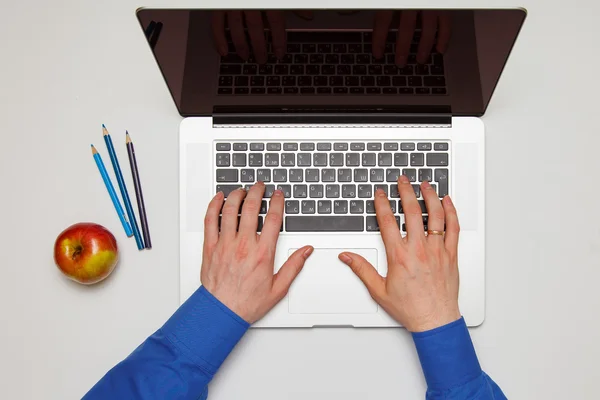 A man is working by using a laptop computer on white table. Hands typing on a keyboard. Top view. Work Concept — Stock Photo, Image