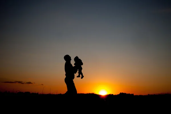 Happy Father holding baby on sunset — Stock Photo, Image