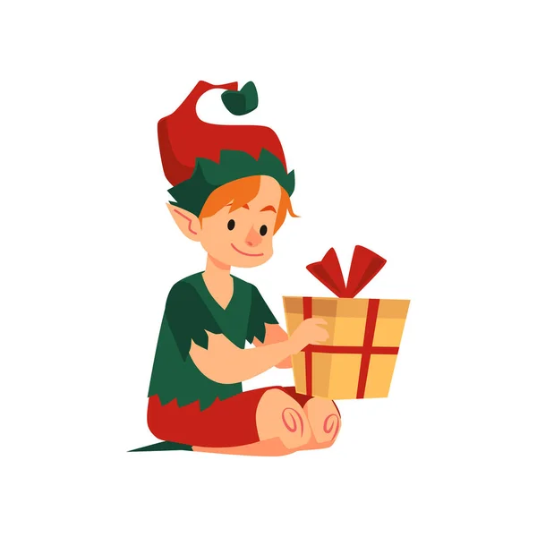 Cute christmas boy elf helper santa claus sit on floor with holiday present. — Stock Vector