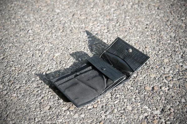 Lost leather wallet on asphalt — Stock Photo, Image