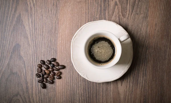 Kopje koffie op houten — Stockfoto