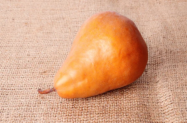 Closeup photo of pear on sackcloth — Stock Photo, Image