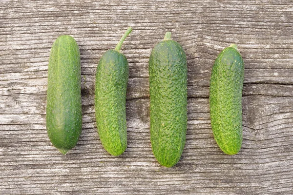 Cucumbers on wooden background — Stock Photo, Image