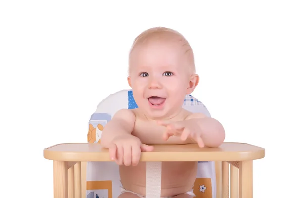 Förtjusande baby pojke väntar på mat sin stol Stockbild