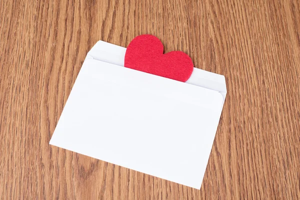 Red heart shape in white envelope — Stock Photo, Image