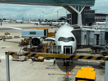 Hong Kong, China - May 16, 2025 : Airport catering truck loading food and drinks onto a cathay pacific airplane, preparing for departure