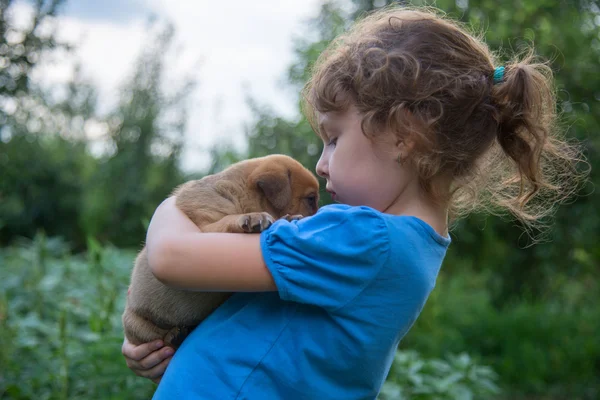 Menina com um filhote nos braços — Fotografia de Stock