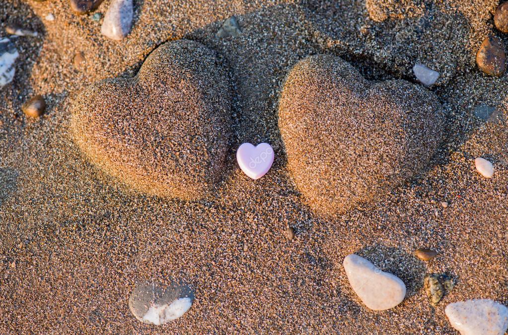 Two sand heart shape in the sand by the sea — Stock Photo © 999vk 66056231