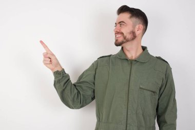 Smiling MODEL pointing up and looking at the camera  clipart