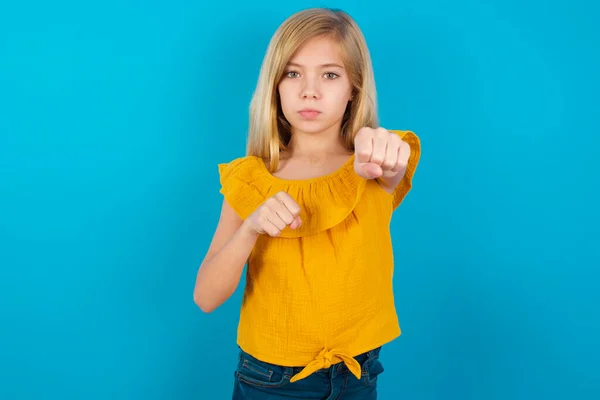 little girl punching fist to fight, aggressive and angry attack, threat and violence