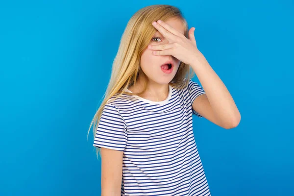 Caucasian Girl Wearing Striped Shirt Blue Wall Peeking Shock Covering — Stock Photo, Image
