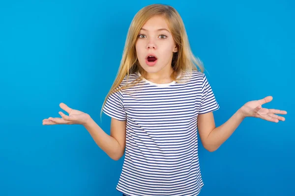 Frustrated Caucasian Girl Wearing Striped Shirt Blue Wall Feels Puzzled — Stock Photo, Image
