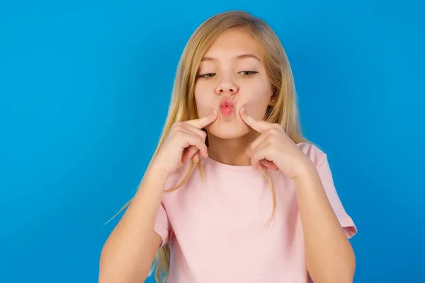 Caucasian Kid Girl Wearing Pink Shirt Blue Wall Crosses Eyes — Stock Photo, Image