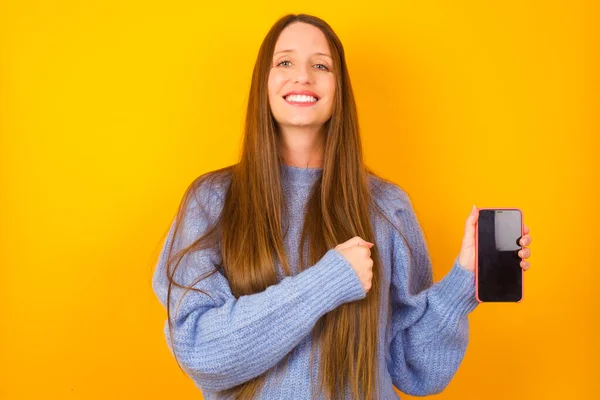 Mujer Joven Sonriente Señalando Con Dedo Índice Teléfono Móvil Con —  Fotos de Stock