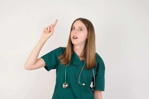 Νεαρή Γυναίκα Γιατρός Δείχνει Προς Πάνω Δάχτυλο — Φωτογραφία Αρχείου