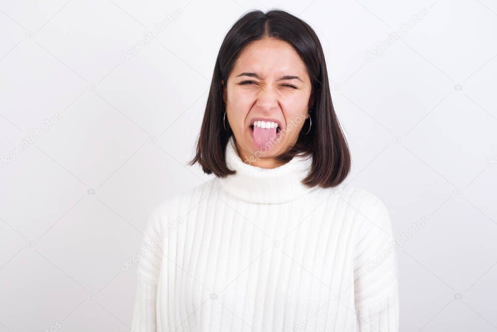 young woman sticking tongue out happy with funny expression. Emotion concept.