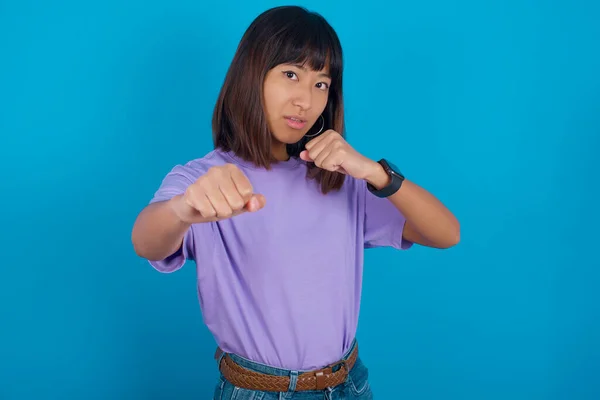 young woman Punching fist to fight, aggressive and angry attack, threat and violence