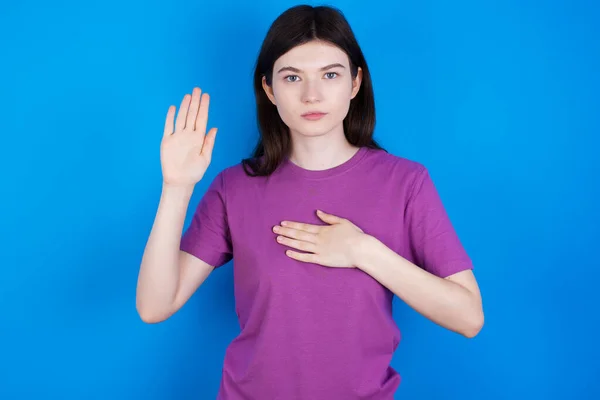 young woman Swearing with hand on chest and open palm, making a loyalty promise oath