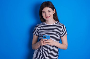 Genç kadın, fotokopi çektir. Cep telefonu kullanmak, SMS iletisi yazmak