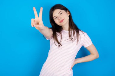 young brunette woman directs fingers at camera selects someone. I recommend you. Best choice