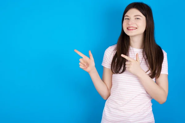 Optimistic Young Brunette Woman Points Both Hands Looking Empty Space — Stok fotoğraf