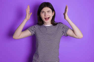 young brunette woman  goes crazy as head goes around feels stressed because of horrible situation