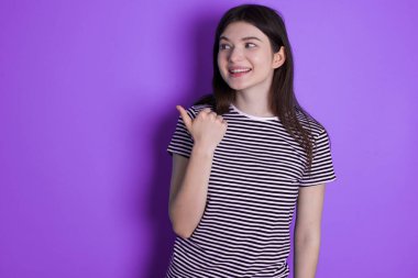 young brunette woman points away and gives advice demonstrates advertisement
