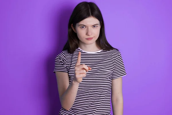 young brunette woman frustrated and pointing to the front