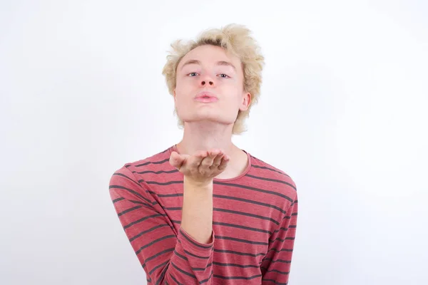 Young Blond Man Looking Camera Blowing Kiss Hand Air Being — Φωτογραφία Αρχείου