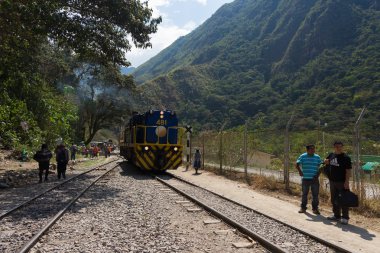 People and baggages on railway track to Machu Picchu, Peru clipart