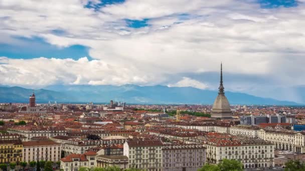 Timelapse video Torino (Turin, Italy) skyline with the Mole Antonelliana towering over the buildings. Wind storm clouds over the Alps in the background. — Stock Video