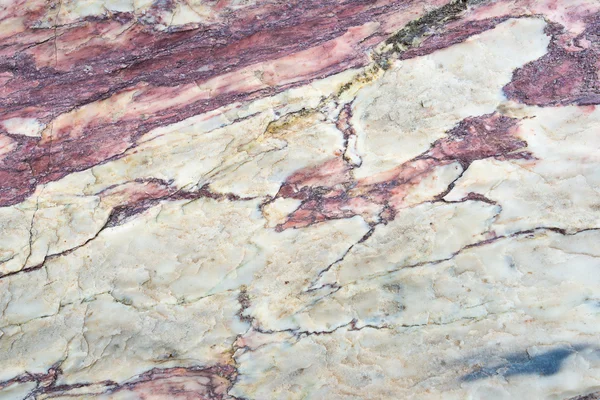 Close up of colorful rock surface, natural background, pattern and texture. Metamorphic white quartzite folded and fractured together with red coarse sandstone, due to the power of geologic crustal mo — Stock Photo, Image