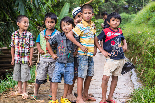 Mamasa, Indonesia - August 17, 2014: Group of unidentified funny children posing, smiling and looking at the camera in the countryside of Mamasa, Sulawesi, Indonesia.