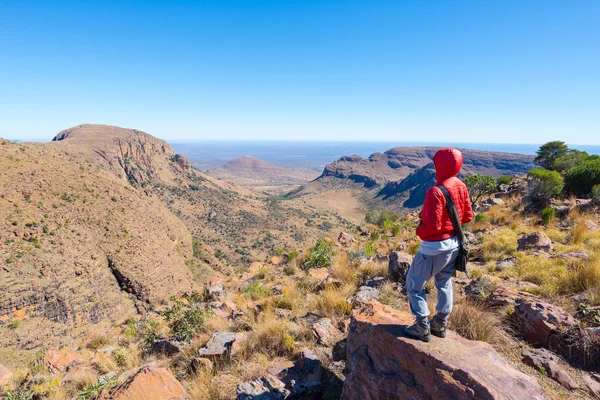 Turista in piedi sulla roccia e guardando la vista panoramica nel Parco Nazionale di Marakele, una delle destinazioni di viaggio in Sud Africa. Concetto di avventura e persone in viaggio . — Foto Stock