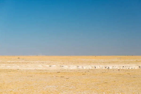 Kalahari desert, salt flat, no where, empty plain, clear sky, road trip in Botswana, travel destination in Africa