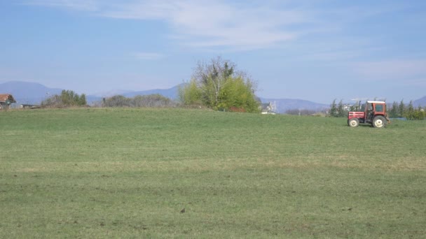 Tractor Working Cultivated Fields Farmland Mountains Agriculture Occupation Lush Green — Stock Video