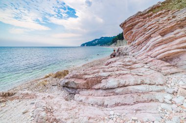 Pebbles beach colorful bay in Conero natural park dramatic coast headland rock cliff adriatic sea tourism destination Italy turquoise transparent water clipart