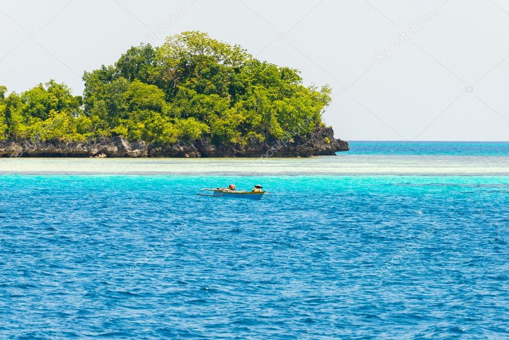 Island, fisherman boat and blue water