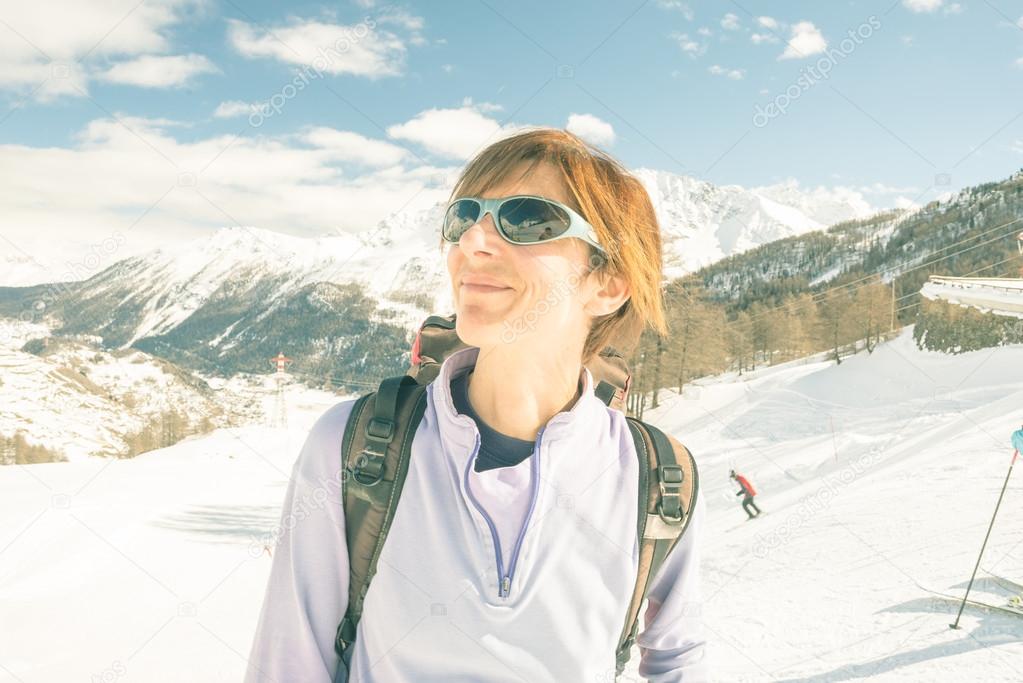 Cheerful female skier in ski resort